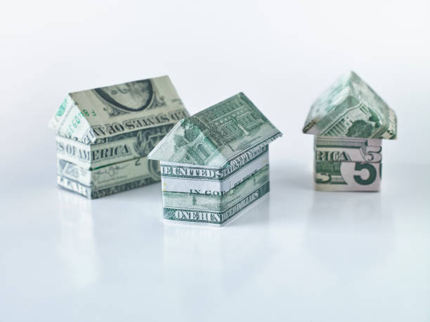 Origami dollar houses Origami dollar houses on white background making money origami stock pictures, royalty-free photos & images
