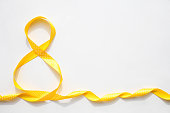 Yellow  ribbon for celebrating gifts in the shape of number 8 on a white background.  International Women is Day 8 March. Copy space. llluminating yellow 