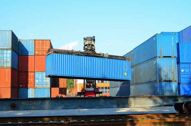 istock Shipping container loading by richtracker on the freight rail car at logistic warehouse port 1294034019
