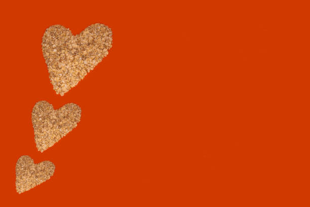 istock Oatmeal hearts on a bright background. The orange table has hearts on the left. 1294036348
