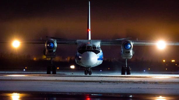 Kostroma Air Enterprise Antonov An-26 Kostroma Air Enterprise Antonov An-26B-100, RA-26133, taxiing from the stand with Follow-Me car. Pulkovo International Airport, Saint-Petersburg, Russia. 18 December 2020 antonov an 26 stock pictures, royalty-free photos & images