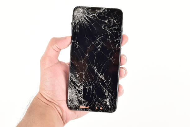 istock cracked screen smartphone in hand isolated on white background, broken smartphone 1294042127