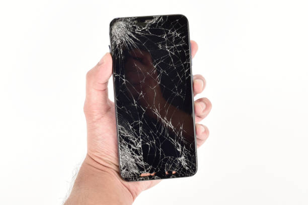 istock Cracked screen smartphone in hand isolated on white background 1294042137