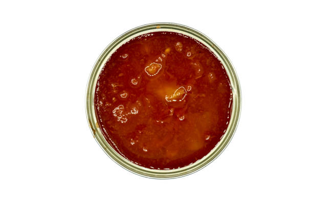 istock Tomato pieces in can isolated on white background top view 1294044012