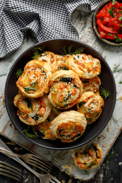istock Puff Pastry Pinwheels stuffed with salmon, cheese and spinach in a ceramic bowl 1294044139