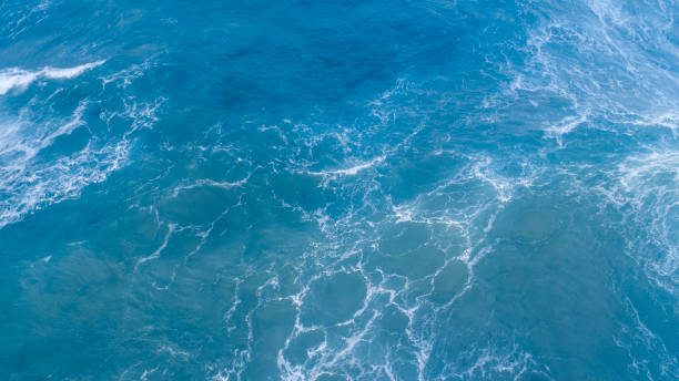 istock Top view of blue waves with natural water texture background 1294045160