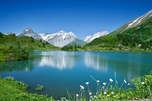 Snow-capped mountains reflecting on the lake; beautiful natural scenery
