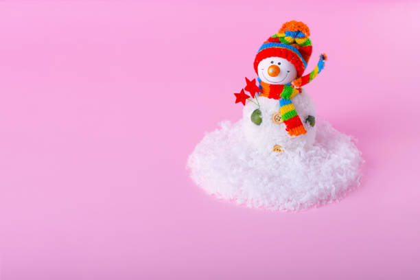 istock Snowman and minimal Winter snow landscape on light pink background. 1294045276
