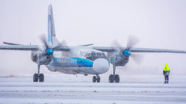 Kostroma Air Enterprise Antonov An-26B-100 Kostroma Air Enterprise Antonov An-26B-100, RA-26133, gets ready for taxiing. Pulkovo International Airport, Saint-Petersburg, Russia. 26 December 2020 antonov an 26 stock pictures, royalty-free photos & images