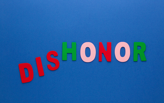 Words dishonor transformed to honor made of colorful alphabet letters on blue background.