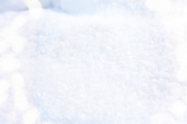 Close up of fresh powder snow framed by a soft circle bokeh. Beautiful fresh winter Christmas background.