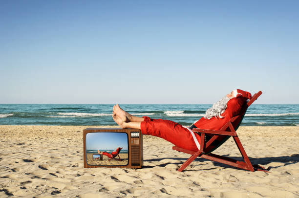 istock Santa Claus on vacation, relaxing and sunbathing on the beach. 1294056681
