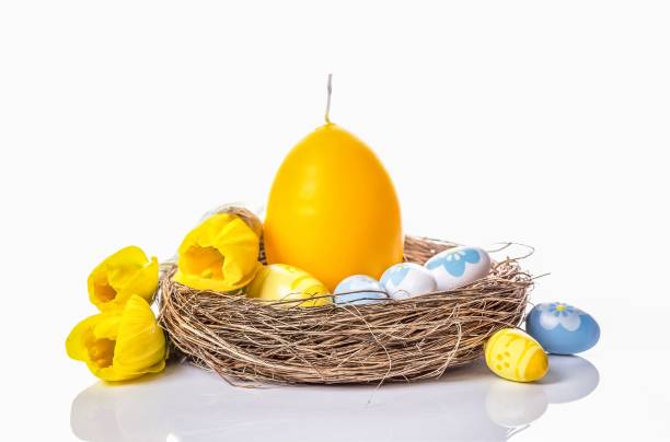 istock Easter eggs, egg candle in the nest and daffodils 1294059295