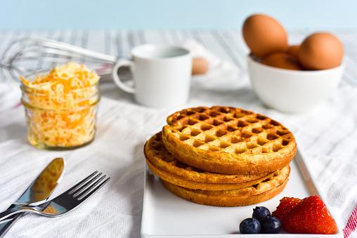 Egg and cheese waffles (Chaffles) on a wooden table
