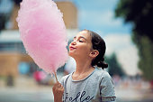 Portrait of little girl eating cotton candy