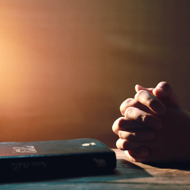 istock Hands and Bible, praying for patients with coronavirus, copy space 1294060758
