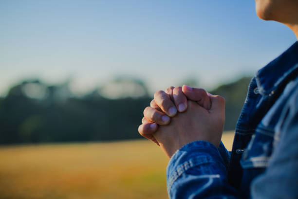 istock Praying to God outdoors for all patients with coronavirus in world, copy space 1294060780