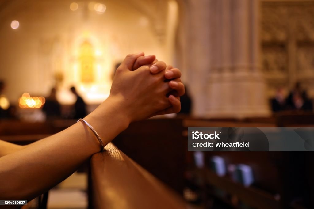 Closeup of woman's hands praying on church bench, coronavirus, copy space Church Stock Photo