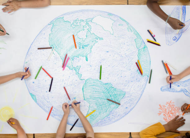 istock Kindergarten children doing a giant doodle of the globe 1294062512