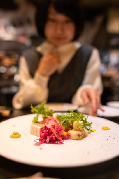 istock Young woman eating dinner at restaurant 1294066388