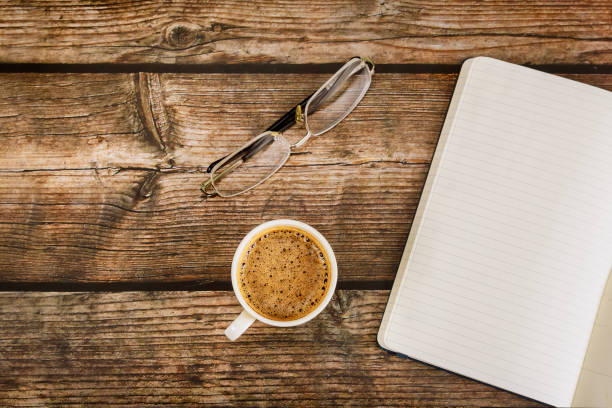 istock Flat lay of modern office table with blank notebook page on coffee cup 1294070591