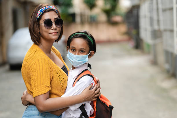 istock Mother and Daughter wearing protective face mask. 1294080446