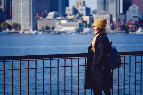 Mid Adult Woman Standing By Cityscape Mid Adult Woman Standing By Cityscape, Boston USA clothing north america usa massachusetts stock pictures, royalty-free photos & images