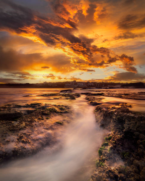 Bondi Beach at sunset Bondi Beach at sunset, Sydney Australia bondi beach sunrise stock pictures, royalty-free photos & images