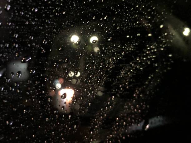 istock A car window with raindrop and bokeh background 1294087950