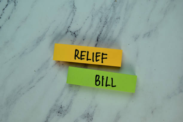 Relief Bill write on sticky note isolated on Wooden Table. Financial concept