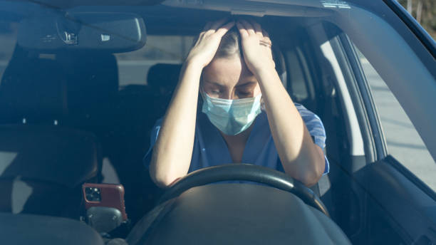 istock Stressed out nurse in car after long day treating patients 1294095547