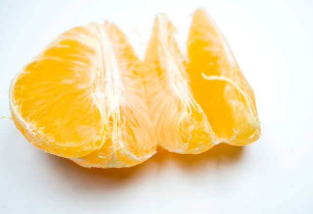 Macro of mandarin orange segments isolated on white background