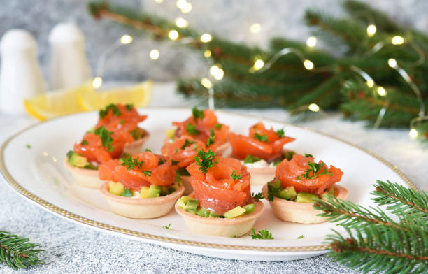 istock Avocado and salmon appetizer on the New Year's table. Tartlets with fish. 1294106806