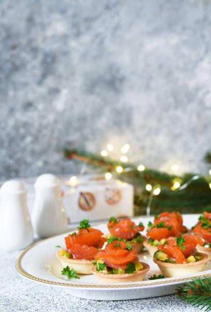 istock Avocado and salmon appetizer on the New Year's table. Tartlets with fish. 1294106833