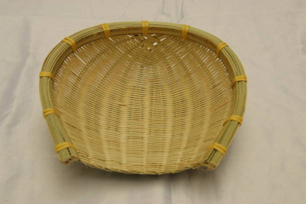 istock Handwoven wicker bamboo dustpan isolated. Traditional brown storage basket 1294110539