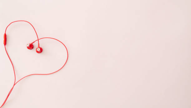 istock Top view of heart-shaped pattern on pastel pink background, copy space 1294110812