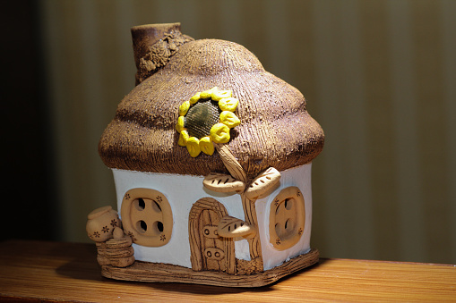 a toy house made of ceramic white-beige