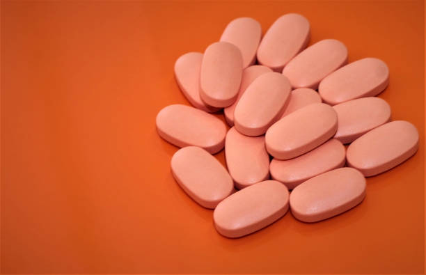 istock vitamin pills on orange background 1294114514