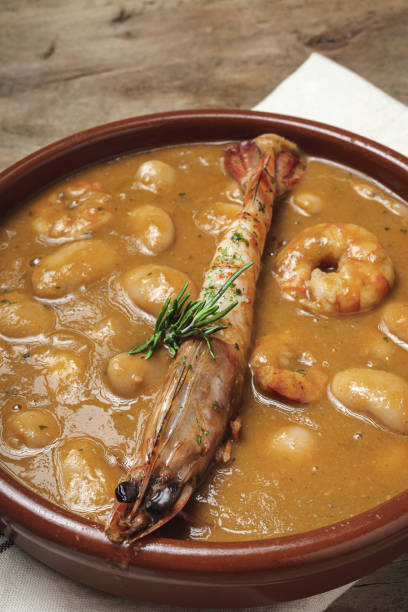 Homemade White Bean Stew with Prawns Traditional Homemade White Bean Stew with Prawns. Typical Spanish food. on wooden background fabes stock pictures, royalty-free photos & images