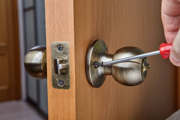 istock Mounting brass doorknob with exposed set-screw, close-up. 1294120696