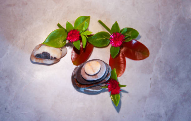 istock Sea stones with flowers on a marble background. Relax 1294120774