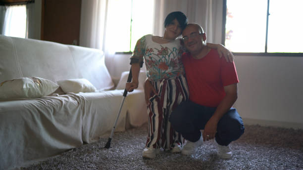 Portrait of woman with dwarfism with her husband at home Portrait of woman with dwarfism with her husband at home dwarf stock pictures, royalty-free photos & images