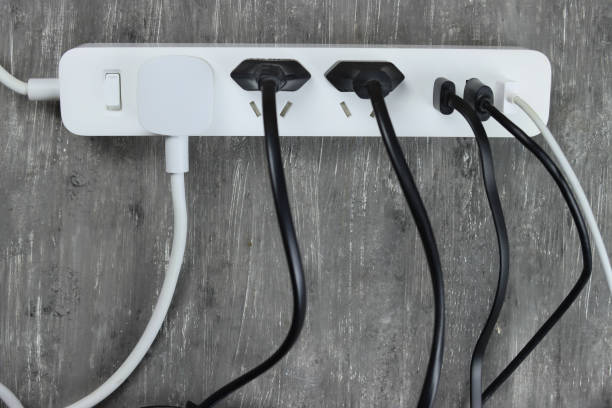 istock Power strip with multiple electrical cords plugged in on gray background 1294125754