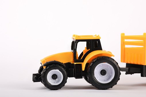 Toy tractor on the white background with copy space
