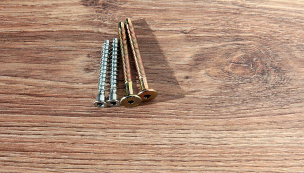 istock Self-tapping screws on a wooden background. Nails 1294131643