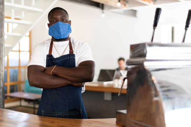 istock Confident African barista behind coffee counter 1294131747