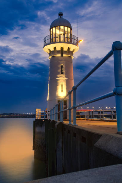 istock Lighthouse beside the ocean 1294133798