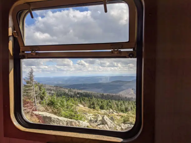 Steam Train on its way up threw the forest to the mountain Brocken in the German Harz. View threw window of the train