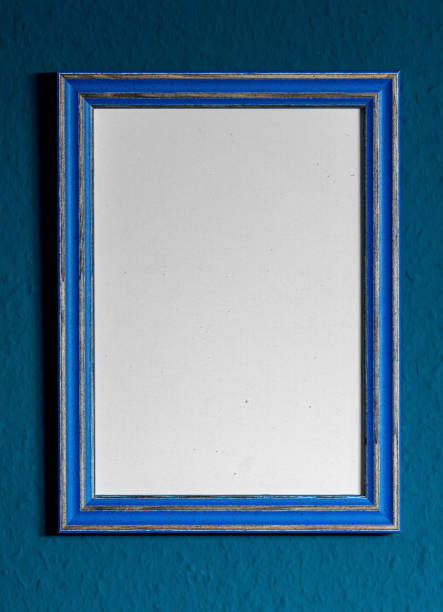 istock empty vintage looking wooden blue frame handing on wall. 1294134713
