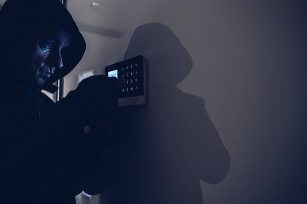istock The thief breaks into the apartment. Disarms the alarm system. 1294134889